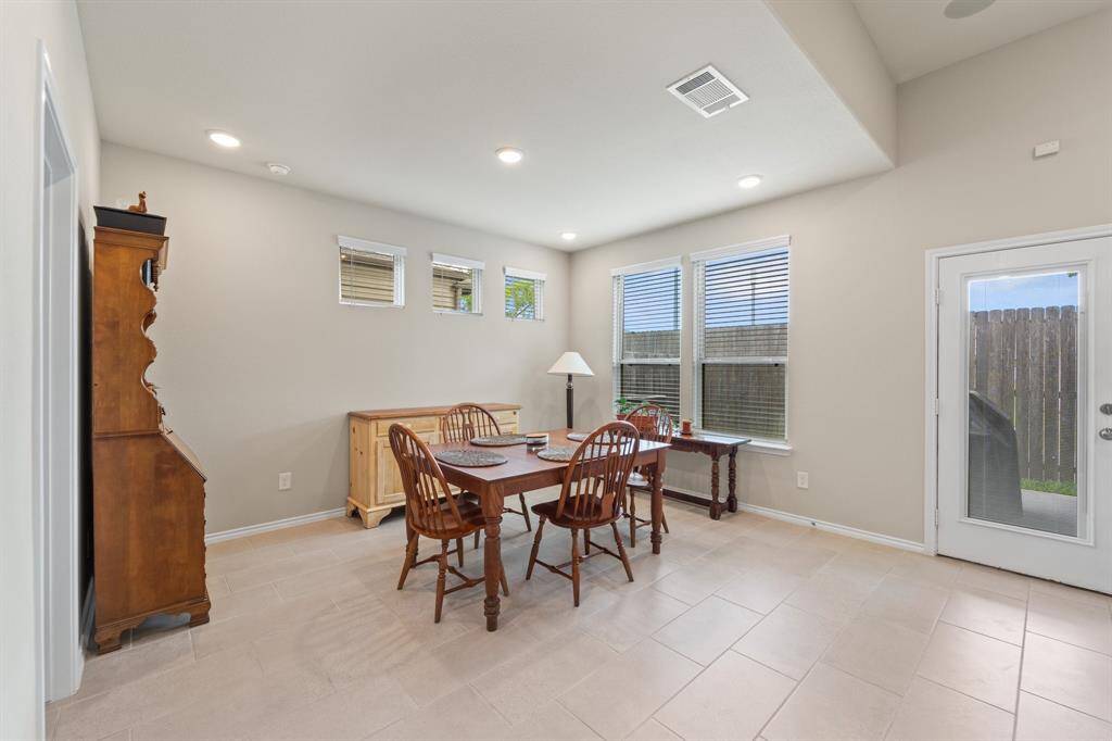 Bright and versatile flex space with backyard access and attached powder room—perfect as a home office, game room, or formal dining for those who love to entertain.