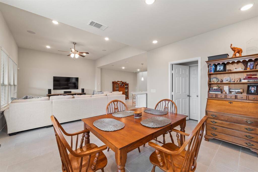 Currently used as a dining area, this flexible space with nearby powder bath offers endless possibilities—home office, second living, or stylish entertaining zone.