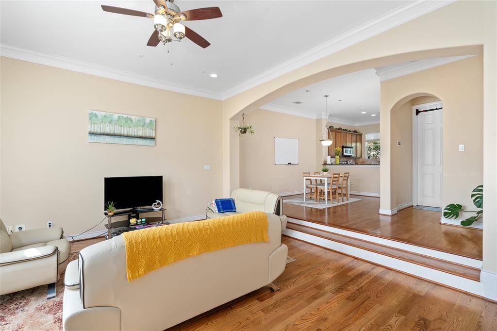 View from the staircase, you’ll enjoy a clear view of the living room, dining area, and kitchen—highlighting the open-concept layout where each space flows seamlessly into the next.