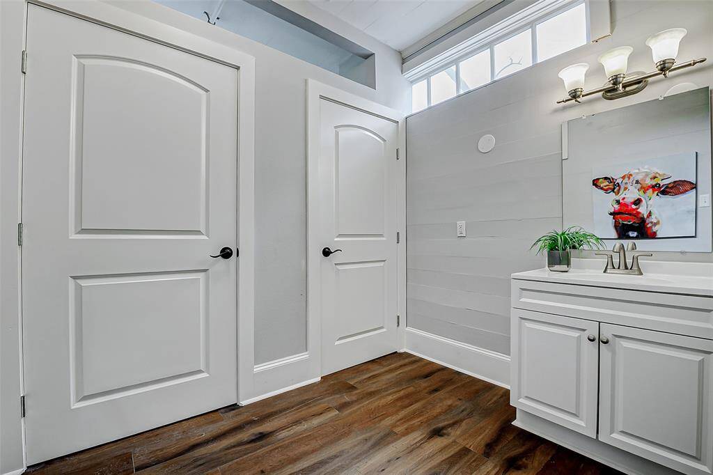 The first floor of this property has been partially converted into a commercial space, offering flexibility for various uses. Shown here are two toilet stalls, but this area could be easily transformed into a primary bathroom. Additionally, there is another half bath located downstairs for convenience