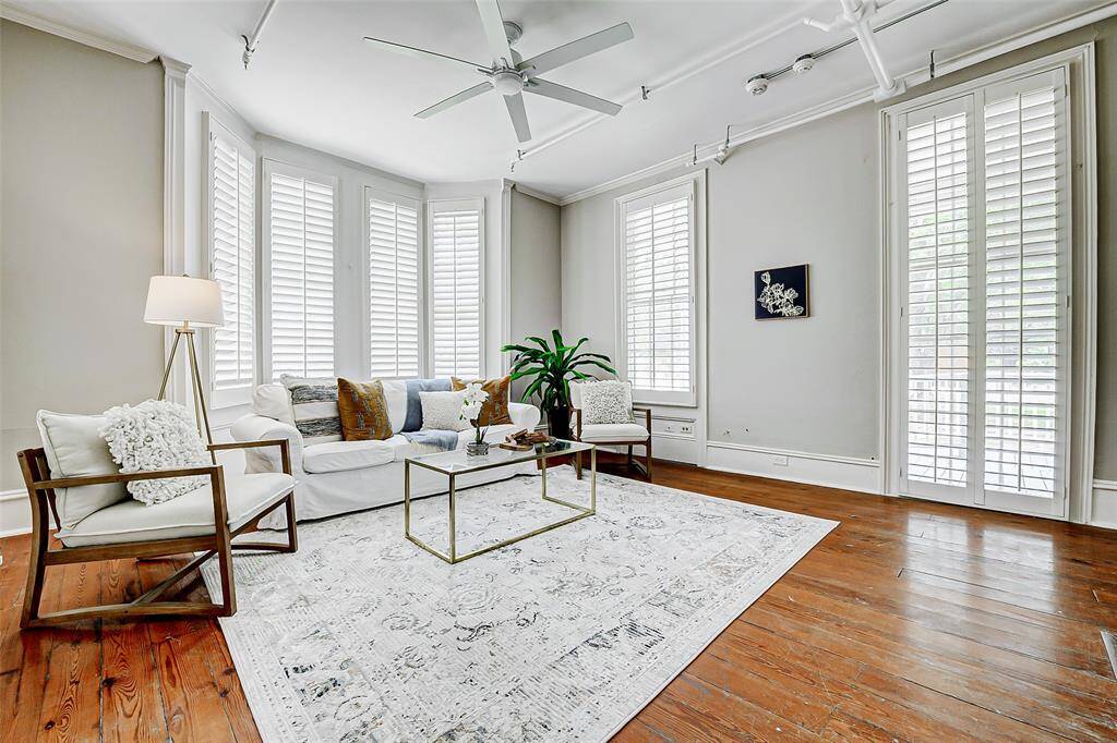 This spacious room is filled with natural light and features plantation shutters. The original wood floors add warmth and character. It can serve as a living room, family room, study, or bedroom, adapting to your needs