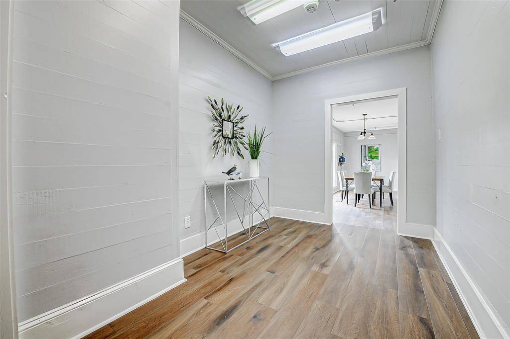 This hallways leads to a spacious sun room, dining room, or break room. Add a couch and/or chairs and this could be the perfect waiting room.