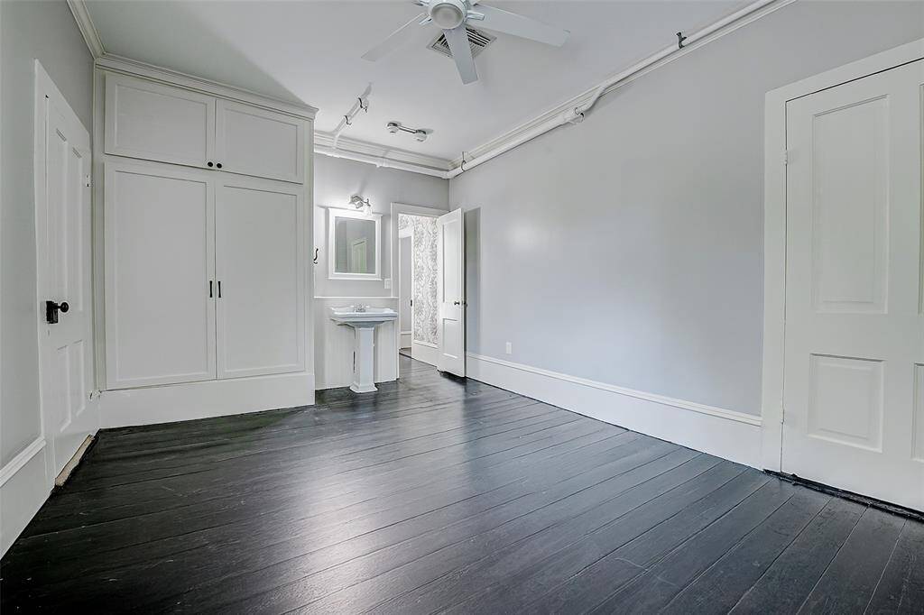 This bedroom features a sink for convenience, large closet, and the door near the sink leads to a full bath. On the left is a "Texas-sized closet," offering tons of room for storage.