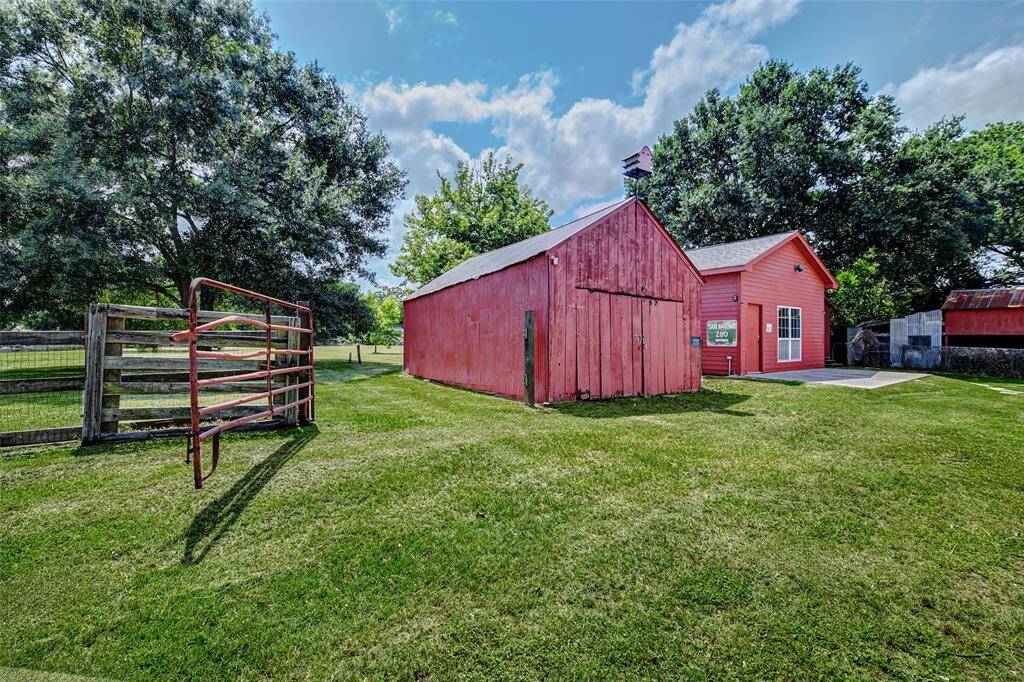 The structure on the left, known as the "Carriage House," was constructed using one of the cabin rooms from the original homestead. The building on the right is a climate-controlled, 20x30 flex space featuring epoxy flooring and a half bath. This versatile area is ideal for various uses, such as a home office, studio, or workshop, providing both comfort and functionality
