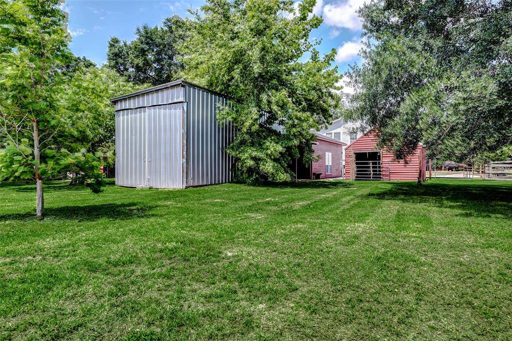 The silver structure opens to store an RV, a boat, or could even be used as stables.