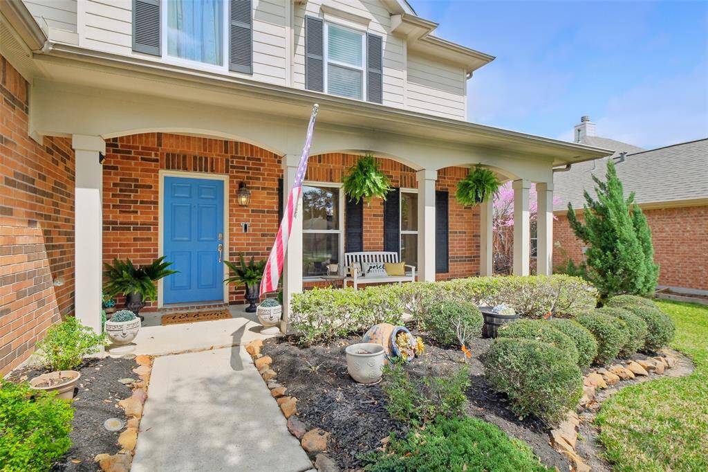 Freshly updated landscaping compliment this all-American porch!