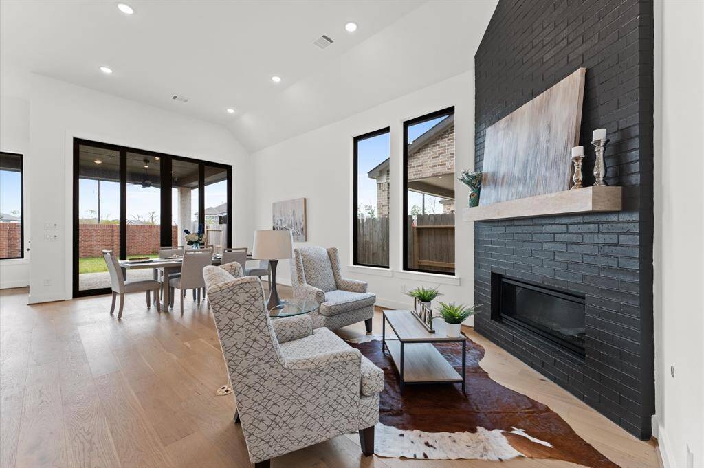 A cozy nook by the fireplace, perfect for quiet moments and warm conversations. Soft lighting and crackling flames create an inviting and peaceful ambiance.