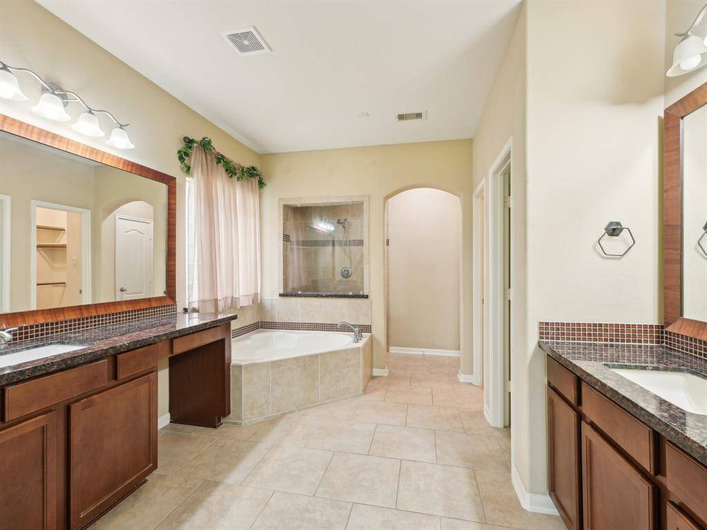 The Primary Bathroom has dual vanities, a fantastic corner tub, separate shower and two walk-in closets.
