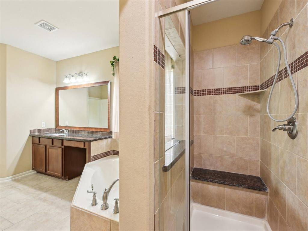 A closer look at the shower with decorative inlay tile.