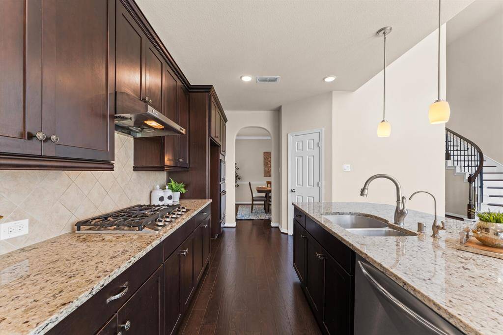 The stainless steel appliances and stylish backsplash make cooking feel like a treat.
