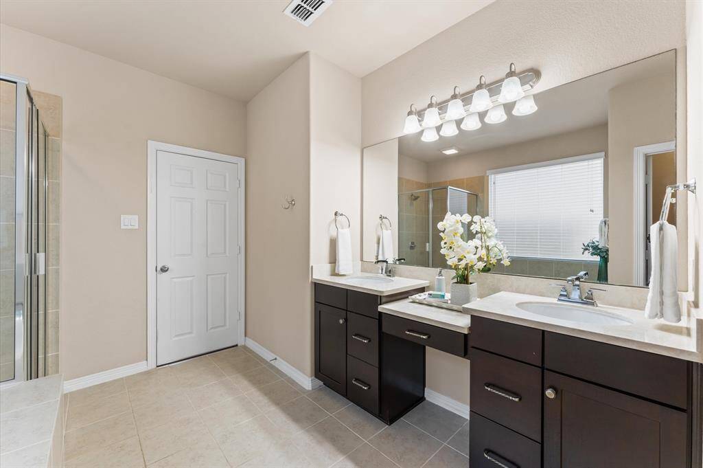 The generous double vanity offers ample space for two, making busy mornings feel calm and unhurried.