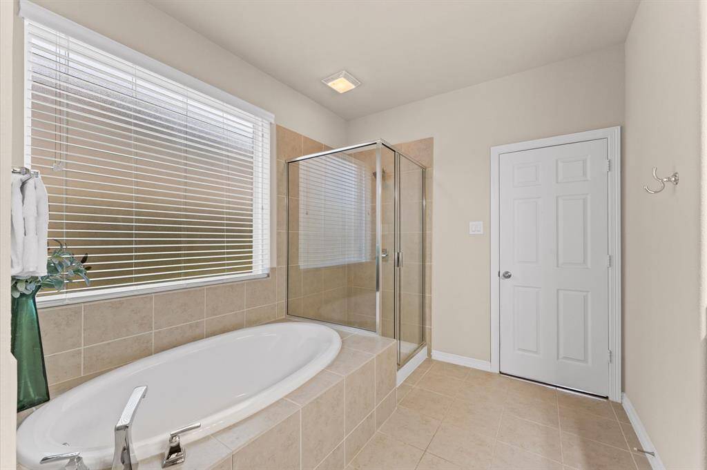 The bathroom features a relaxing garden tub, perfect for soaking the day away in peace and quiet.