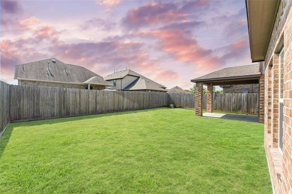 The manicured lawn is a beautiful canvas for play and gatherings. There’s room to run, relax, and make memories under the open sky.
