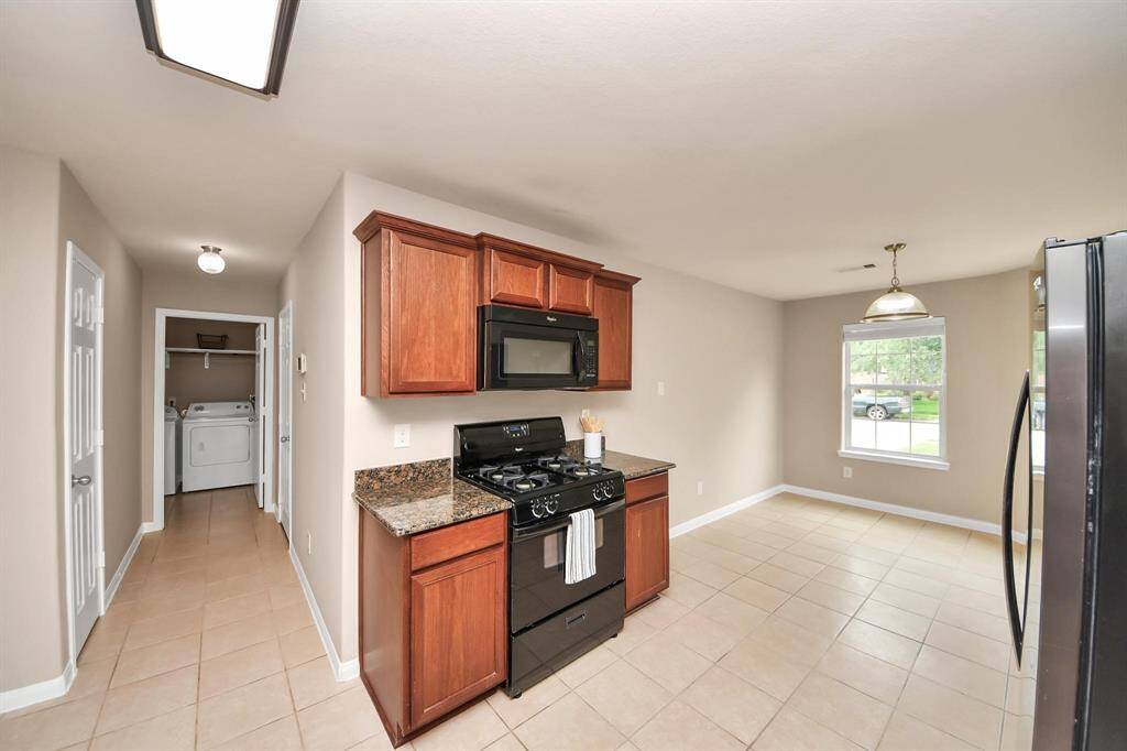 View of the Kitchen/Dining down the hallway to the Pantry, Garage, and  Laundry Room