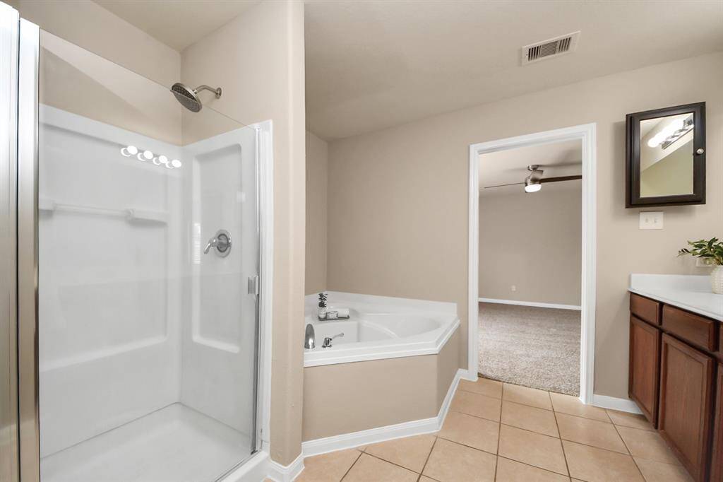 The separate walk-in shower is nice for a quick cleanse, but you can also relax in your very own soaking tub.