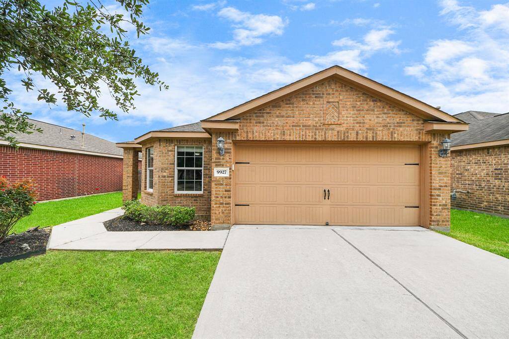 Front view shows the attached, 2-car garage with double driveway and freshly power washed walk