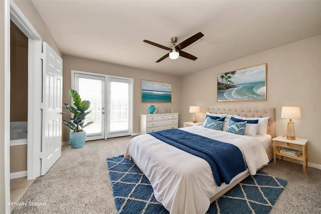 Virtually staged Primary Bedroom with a private entry from the back patio.