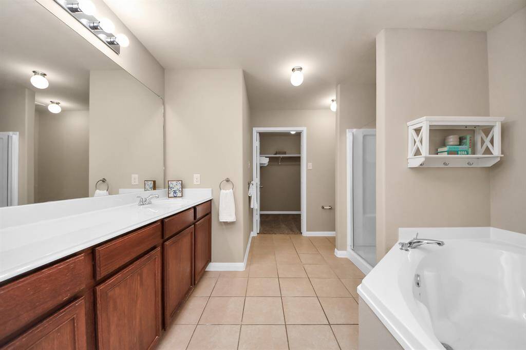Large, Primary Bathroom Ensuite with garden soaking tub, separate shower, and spacious closet!