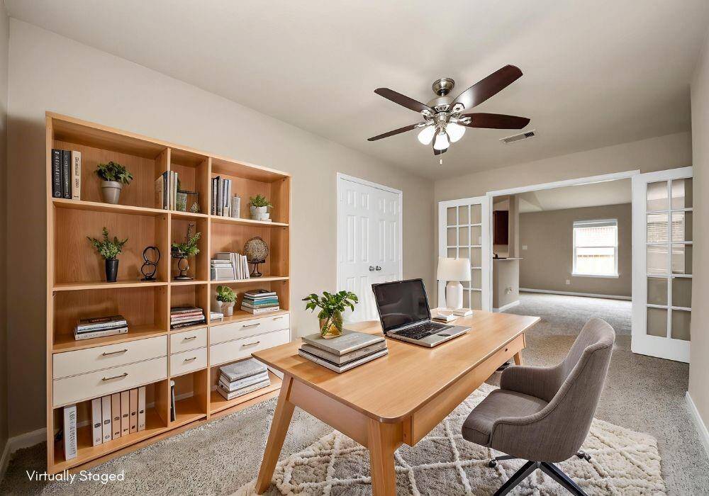 Flex space, virtually staged to show a Home Office option. With a closet and French doors, this room can also become a 4th bedroom.