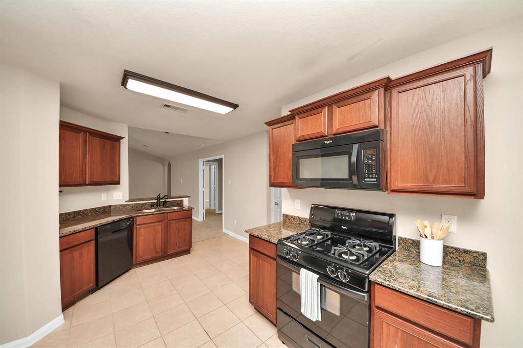 Spacious Kitchen with a view to the living room and plenty of counter space for dinner prep!