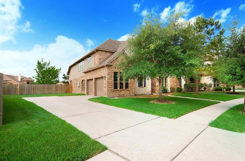 Side view of driveway leading up to the two car garage