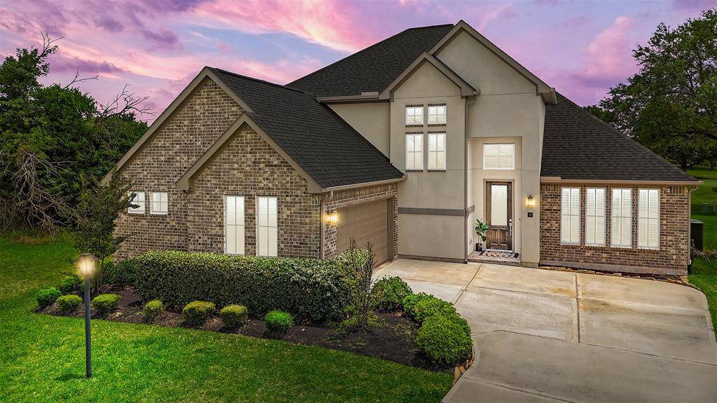 Welcome to 10 Bermuda Circle! This 2020-built home features a stunning brick and stucco facade, a lush, manicured lawn, and a spacious side-load garage that enhances its curb appeal.