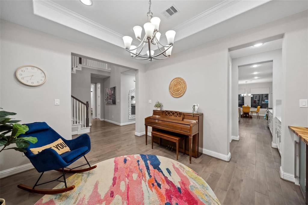 From the dining area, enjoy a beautiful preview of what’s to come—a graceful staircase, a peek into the kitchen, and the warm, welcoming heart of the home just beyond.