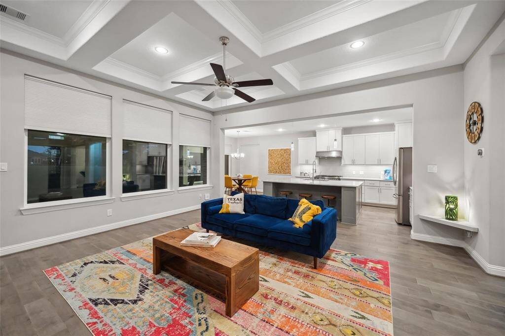 The open-concept design connects the living room effortlessly to the kitchen, creating a spacious, connected atmosphere perfect for everyday living and entertaining.