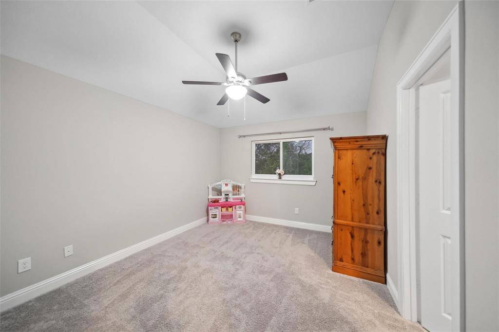 This inviting secondary bedroom offers ample space, natural light, and a peaceful atmosphere—ready to adapt to your family’s needs, whether as a guest room, playroom, or personal retreat.