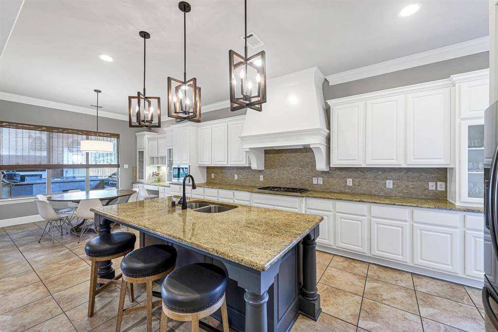 Beautiful light and airy kitchen with gorgeous vent hood.  There is a tremendous amount of storage in this kitchen. Weeknight meals and holiday extravaganzas are a breeze in this space.