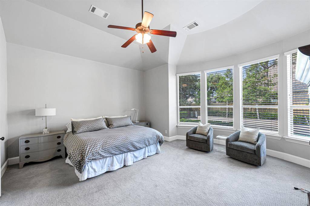 Large primary bedroom complete with a wall of windows, en suite bath and large walk in closet.  Very spacious, light and bright.