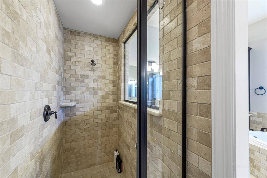 Large walk in shower with window to the main bath to let the light in.