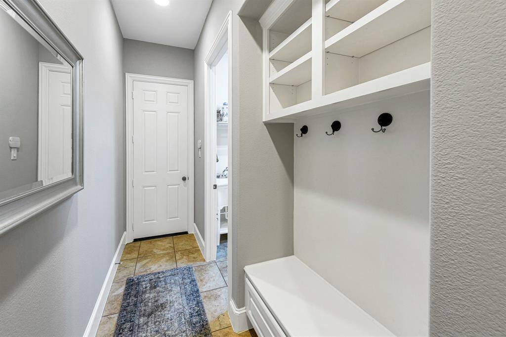 Drop those bags and shoes and hang up those jackets on the way into the house with this fabulous mud room built in space.