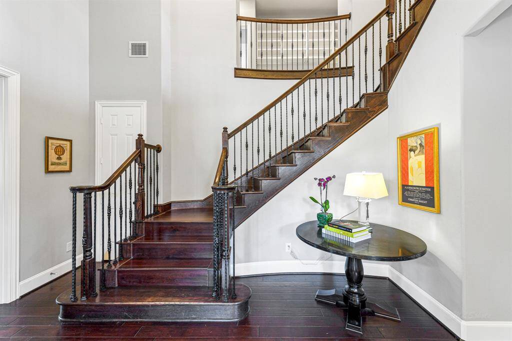 Beautiful wooden staircase leading to the second floor of this stunning home.