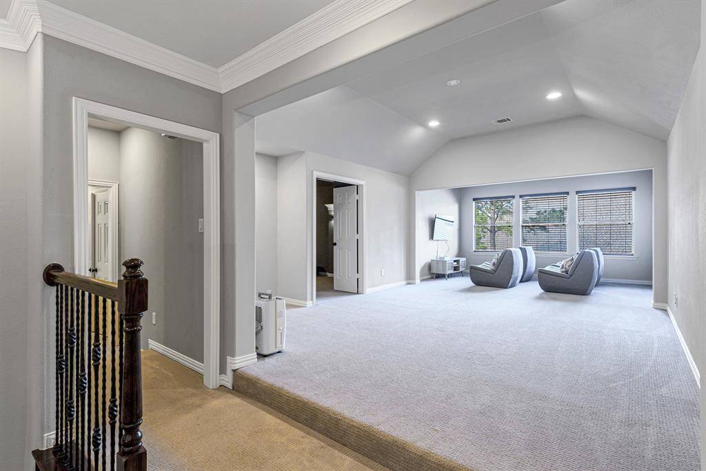 At the top of the stairs step up into the land of fun with this huge game room and media room.