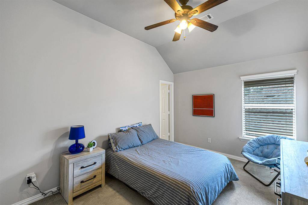 The third of four bedrooms upstairs in this beautiful home. Full size bed, dresser, nightstand and chair fill the space comfortably with room to spare.