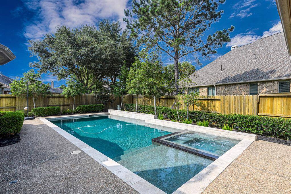 Gorgeous pool and spa surrounded by luxe yet simple landscaping.