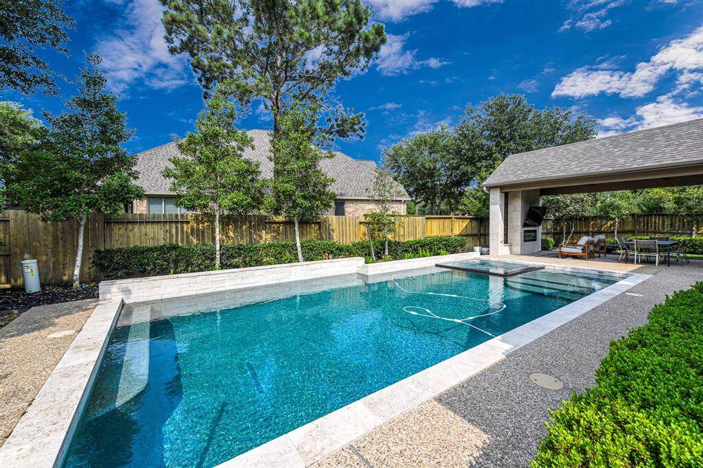 Another view of the beautiful pool and large covered patio.