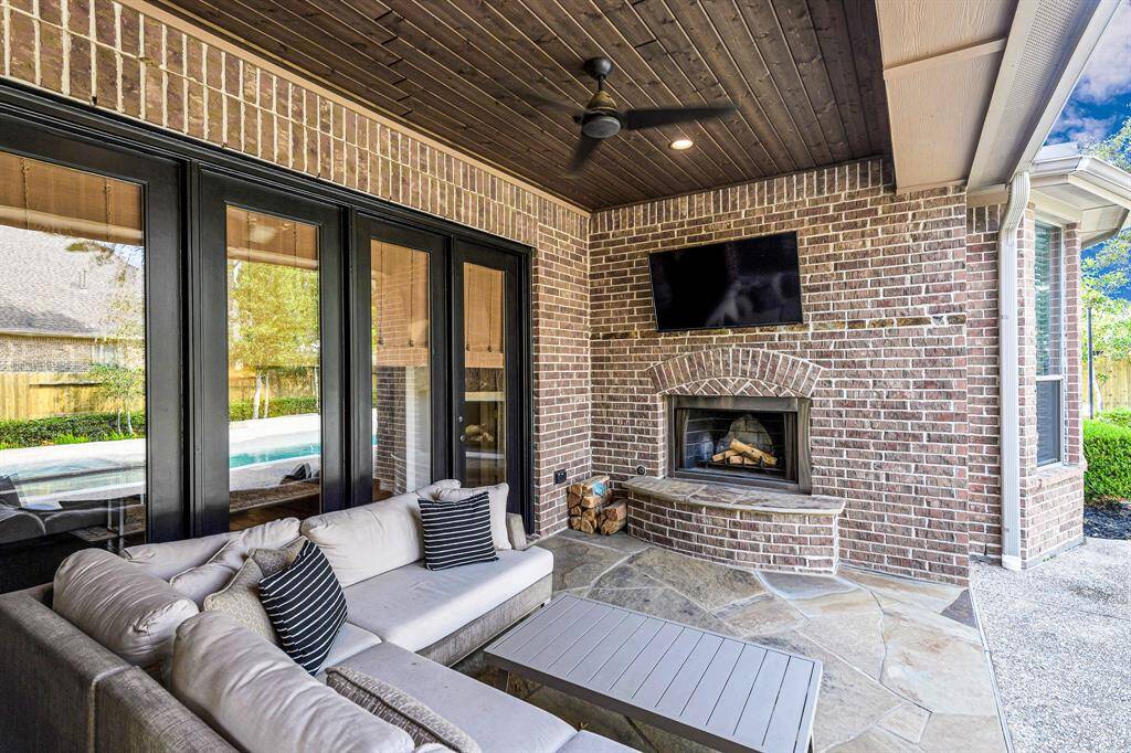 Outdoor brick fireplace for those cool Houston nights.  This space is just lovely.