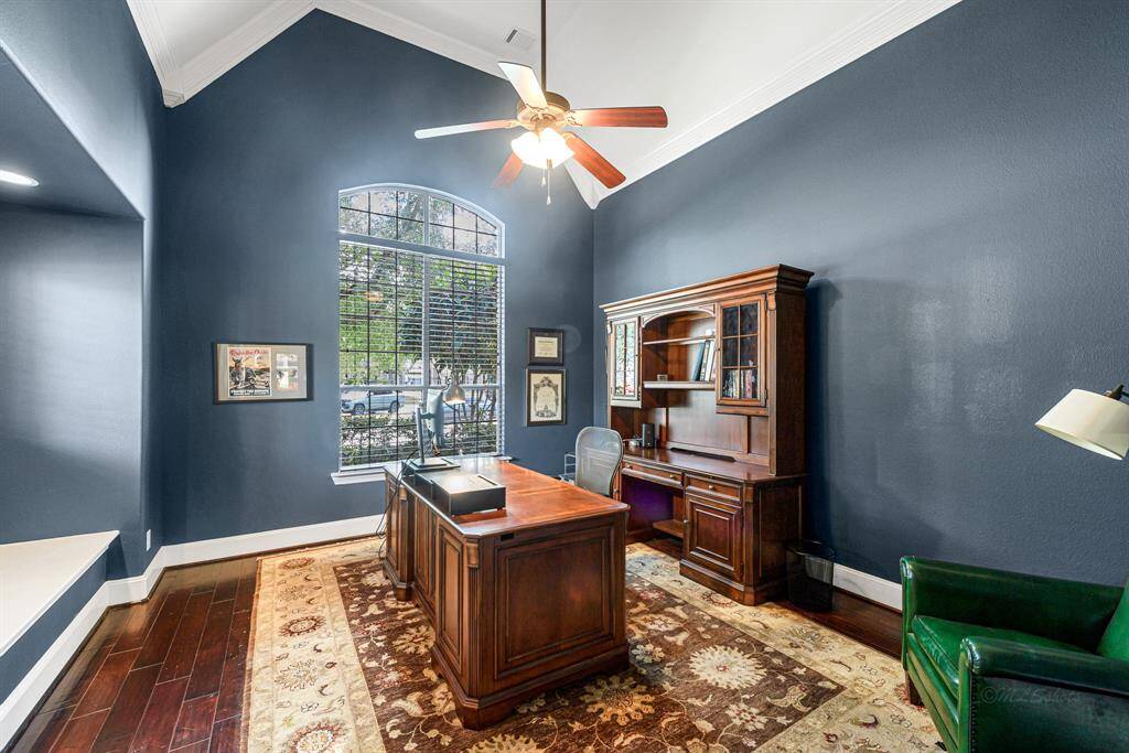 Light and bright home office complete with window seat, rich paint color and high ceilings with architectural details.  Perfect place to work or craft.