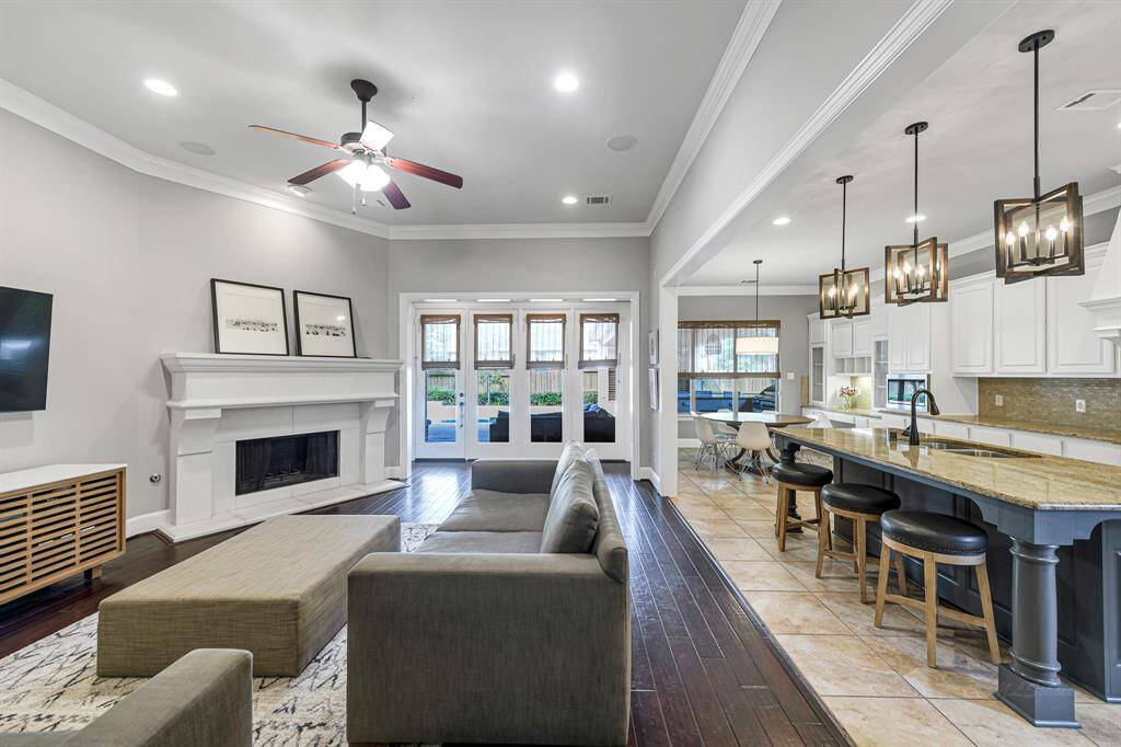 Here is a view into the heart of the home.  Beautiful kitchen with lots of cabinets for storage.  Gorgeous cast stone fireplace.  The wall of windows let in a tremendous amount of light and provide the perfect view to the amazing backyard.  The breakfast room is the ideal size for a family.