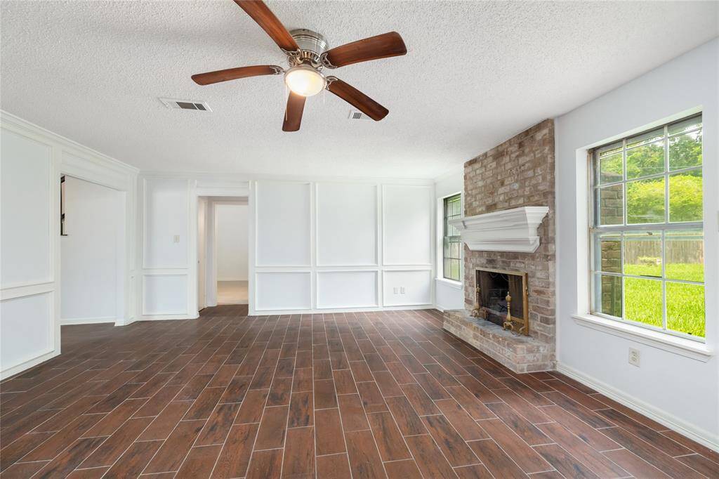 With seamless access to the covered patio and a versatile layout, this space invites you to imagine cozy evenings by the fire or lively weekends spent entertaining.