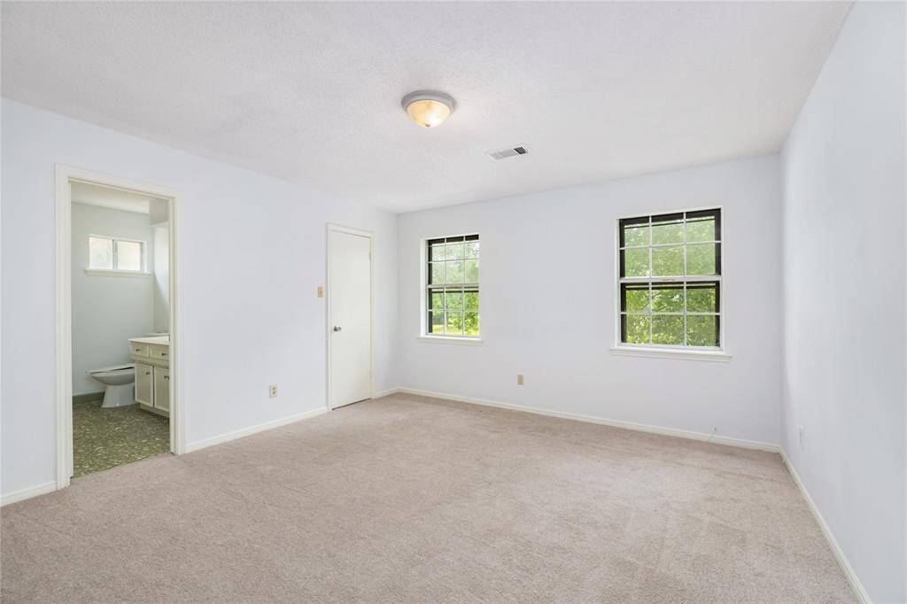 Upstairs, a secondary bedroom with its own private ensuite is ideal for a mother-in-law suite, guest space, or simply comfortable, flexible living.