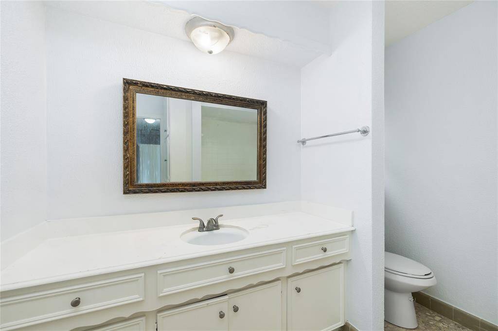 A well-appointed secondary bathroom offers convenience and comfort with neutral finishes and thoughtful storage.