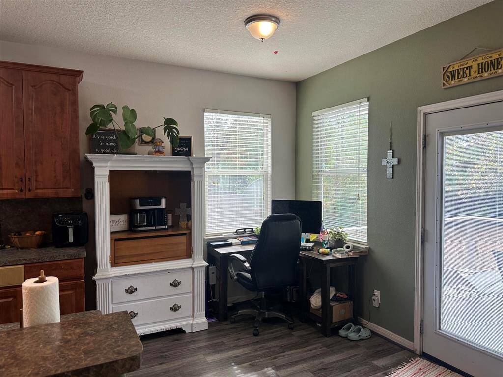 This breakfast nook invites natural light with the corner windows and the glass back door.