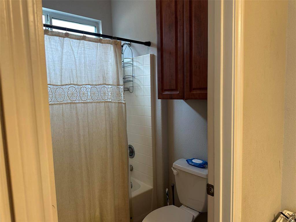 En-suite bath with separate shower/toilet area.