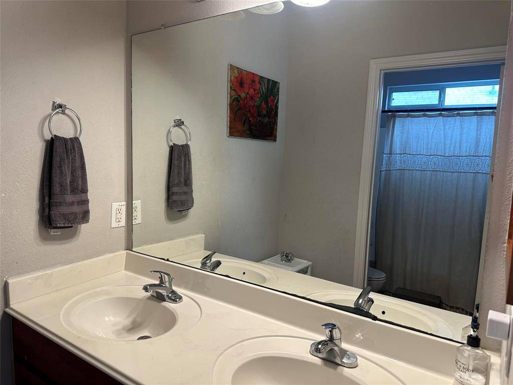 Primary bath with separate vanity area, double sinks and storage.