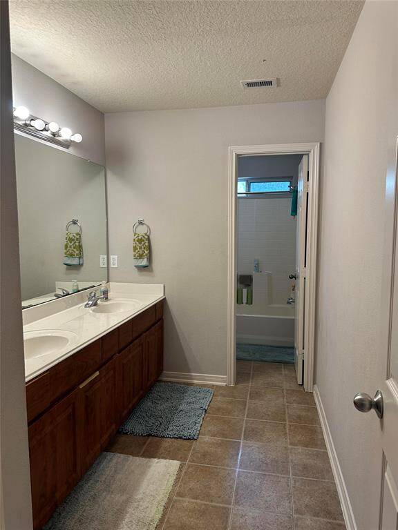Upstairs bathroom is situated between bedrooms 2/3 and 4/5 and has double sinks and a separate toilet/shower/tub area.