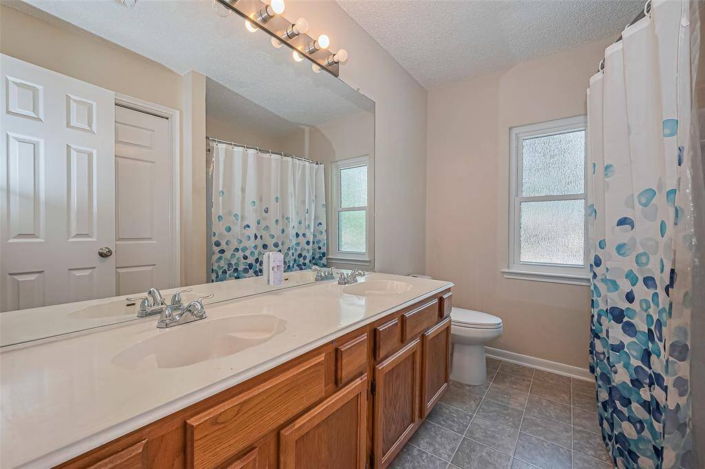 The secondary bathroom is located upstairs.  It offers double sinks and a tub/shower combo.