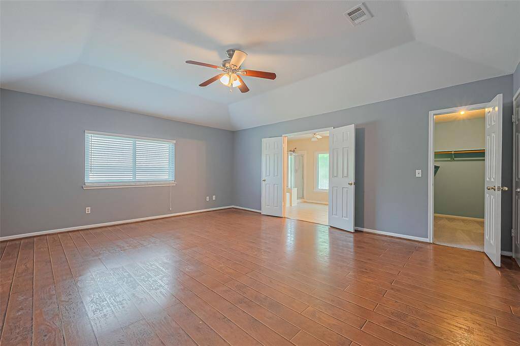 The primary bedroom is very spacious with a large primary bath and walk in closet.